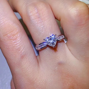 Silver ring with heart-cut moissanite and baguette accents