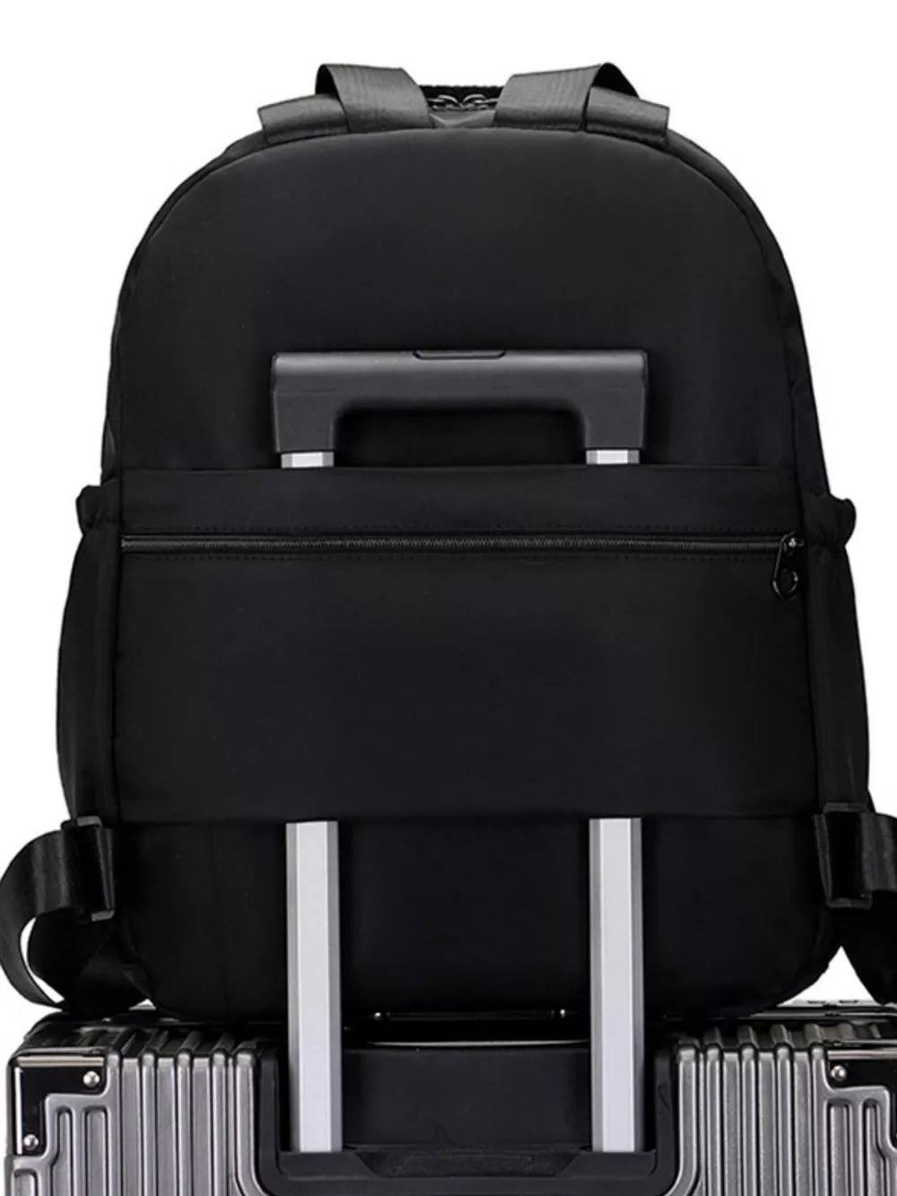 Black Oxford cloth backpack with trolley sleeve and adjustable straps.