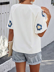 White short sleeve blouse with embroidered blue floral yoke detail