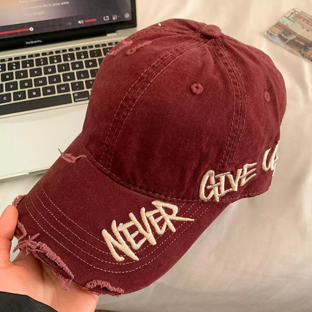 Wine red distressed denim baseball cap with embroidered "NEVER GIVE U" text.