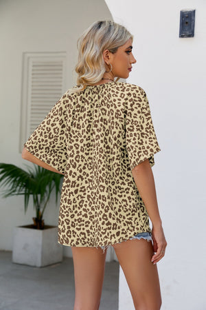 Tan leopard print v-neck blouse with short sleeves.