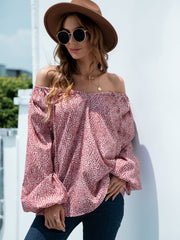 Off-the-shoulder blouson top in deep red spotted print with balloon sleeves.