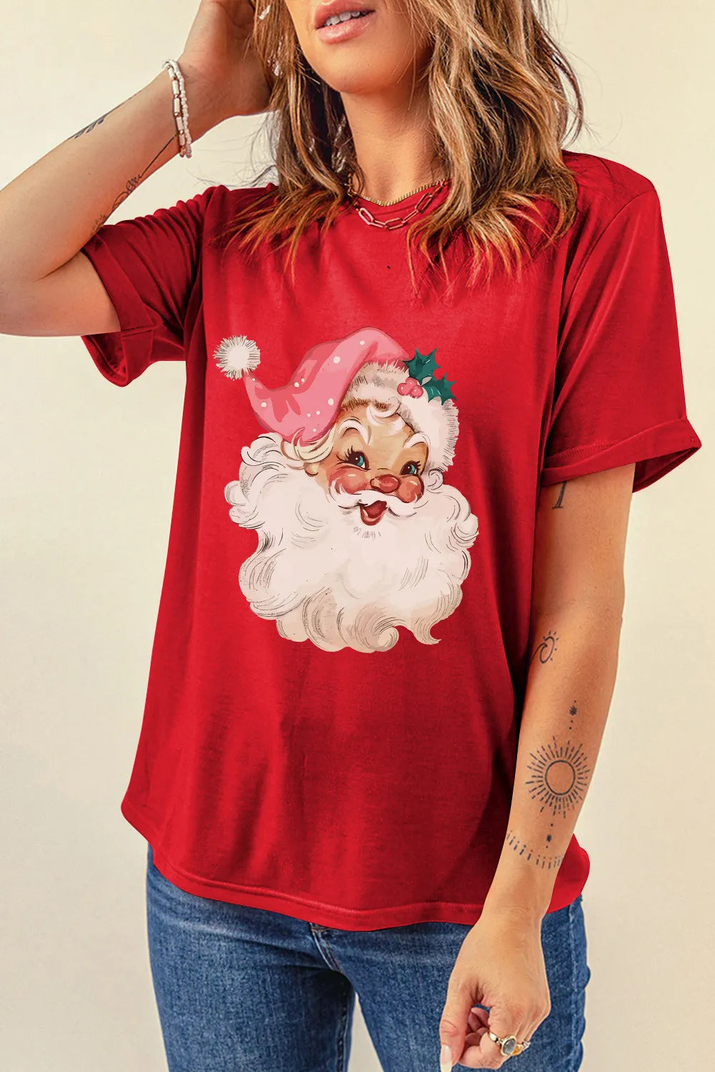 Red graphic t-shirt with a retro Santa Claus print and short sleeves.