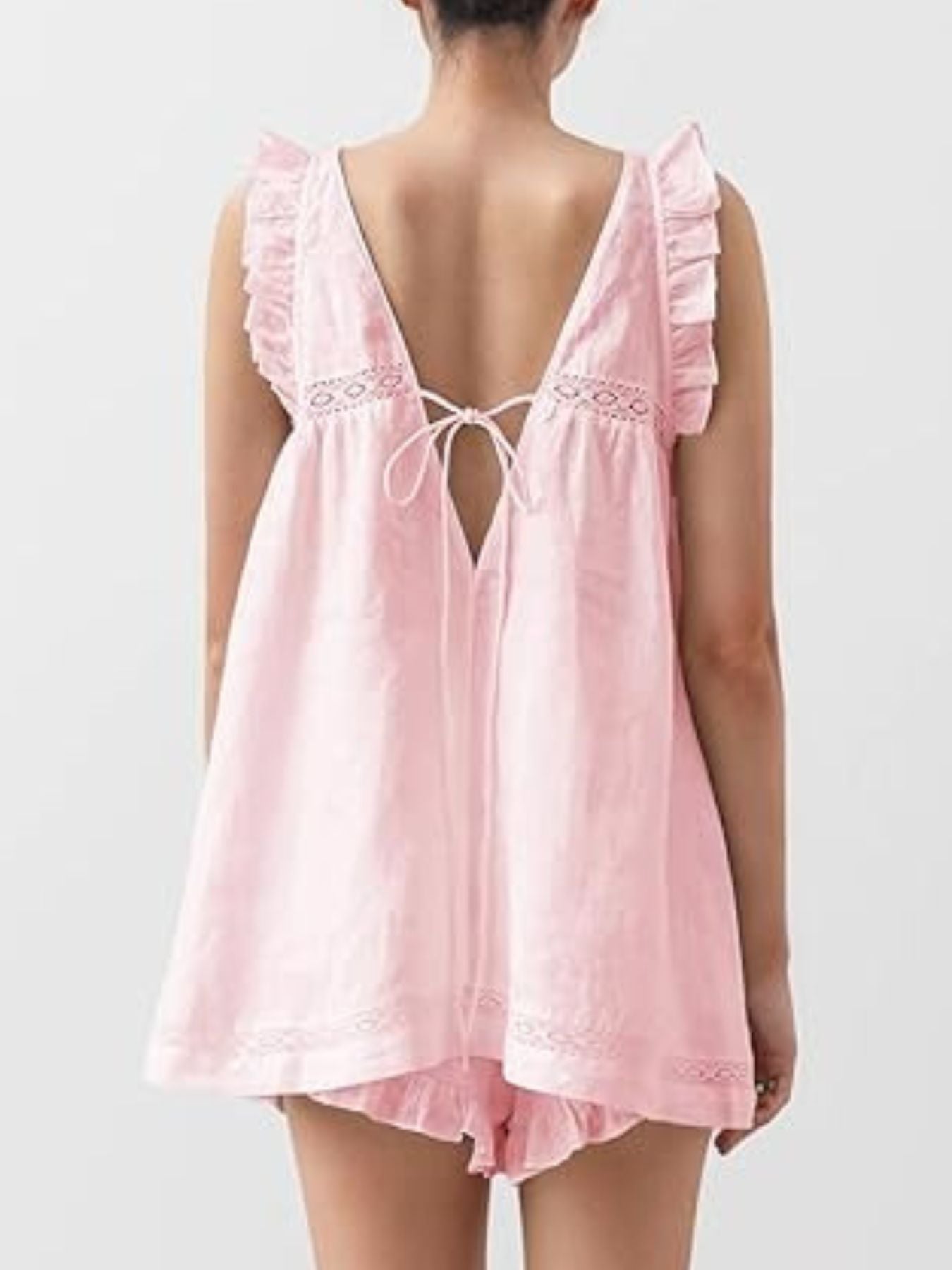 Blush pink ruffled V-neck top and shorts set with lace trim and tie back.
