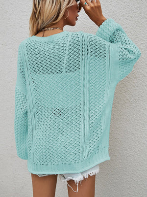 Open-knit cardigan in turquoise with balloon sleeves and a button front.
