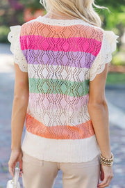 Rainbow crochet blouse with flutter sleeves and diamond pattern in stripe colors.
