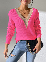 Pink openwork knit sweater with lace trim and V-neck.
