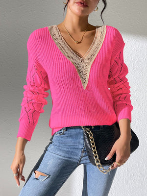 Pink openwork knit sweater with lace trim and V-neck.