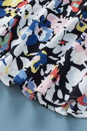 Dalmatian trim floral print blouse with black and white background and colorful abstract flowers.