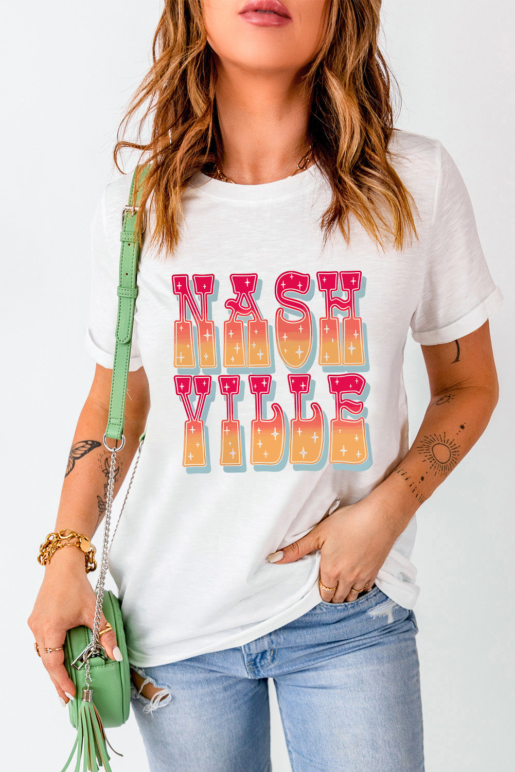 White t-shirt with "Nashville Vibe" in retro gradient typography and sparkle details.