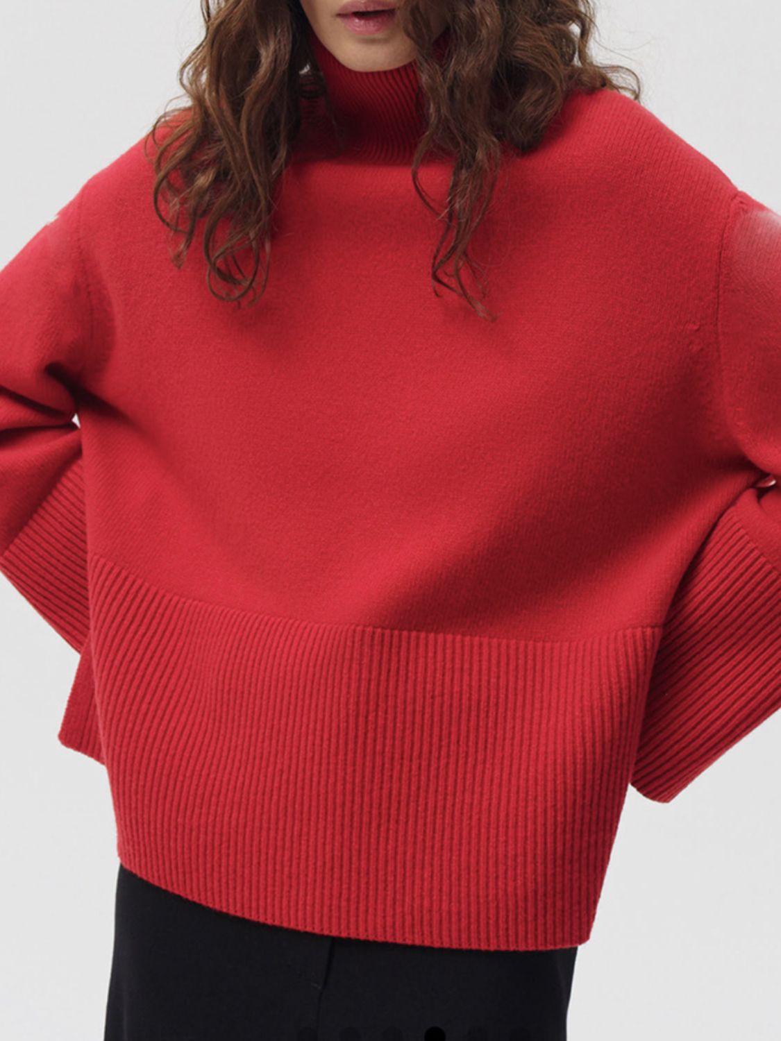 Deep Red ribbed turtleneck sweater with flared sleeves and a ribbed hem.
