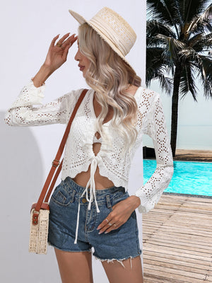 White crochet tie-front cover-up top with bell sleeves and adjustable drawstring.