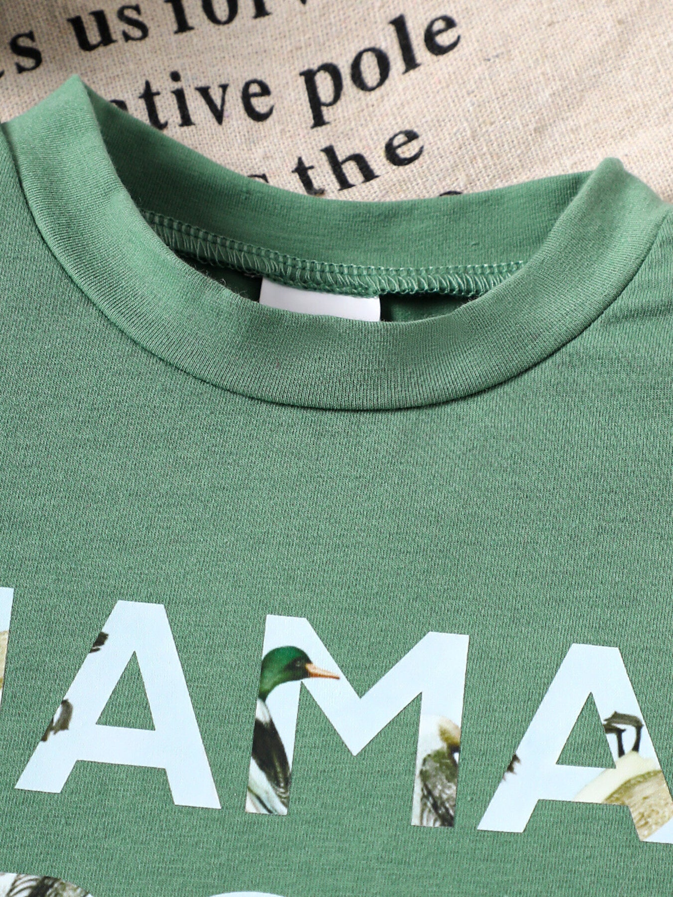Green cotton blend baby tee with Mama's Boy graphic and duck images.