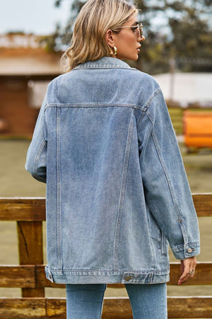 Oversized denim trucker jacket in medium wash with classic button details and collar.