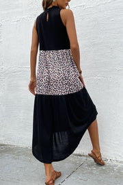 Black leopard print tiered halter dress with a mock neck and button back detail.