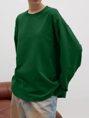Oversized crewneck sweatshirt in dark green with voluminous sleeves.