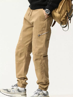 Men's Khaki cotton cargo pants with zipper pockets and elastic cuffs.