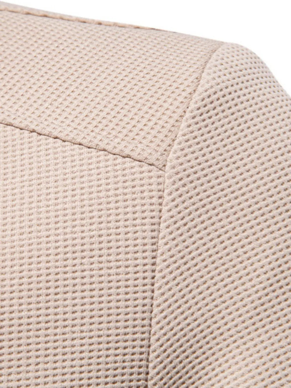 Taupe textured knit bomber jacket detail showing waffle weave fabric and seam.
