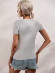 Light Gray knit t-shirt with short sleeves and a ribbed texture, styled with denim shorts.