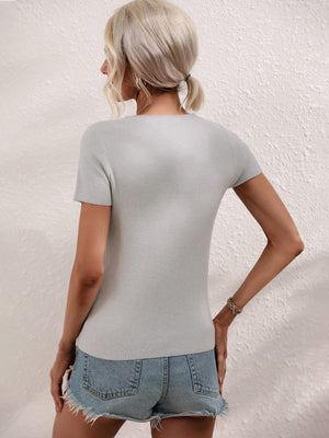 Light Gray knit t-shirt with short sleeves and a ribbed texture, styled with denim shorts.