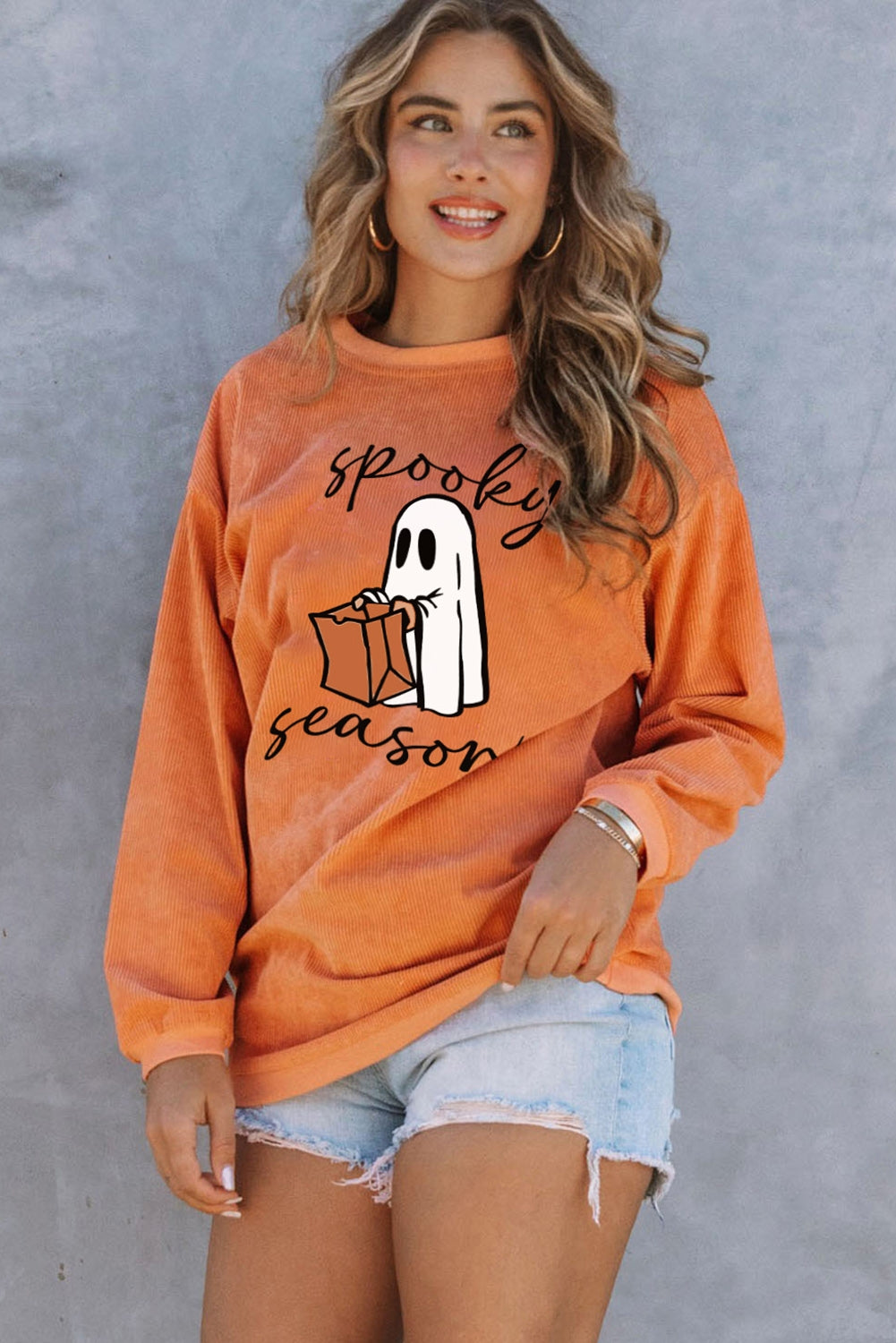 Orange corduroy sweatshirt with "Spooky Season" ghost graphic, crewneck, long sleeves.