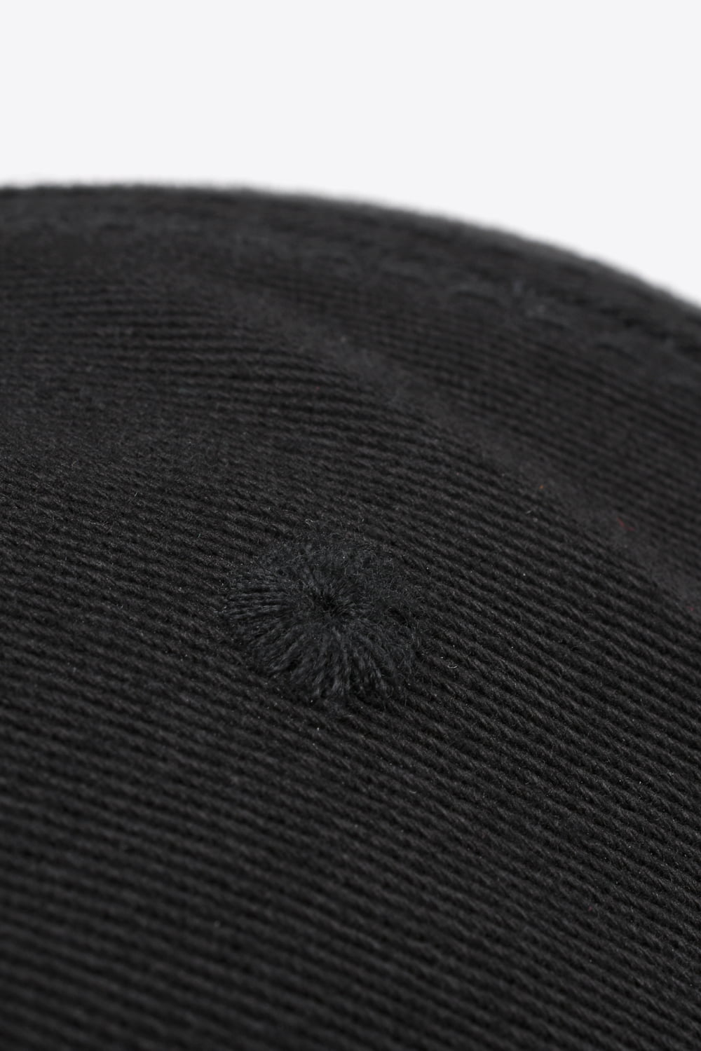 Black baseball cap with textured fabric and embroidered detail