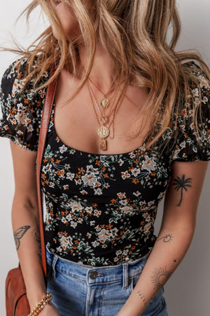 Black floral puff sleeve bodysuit with a square neckline.