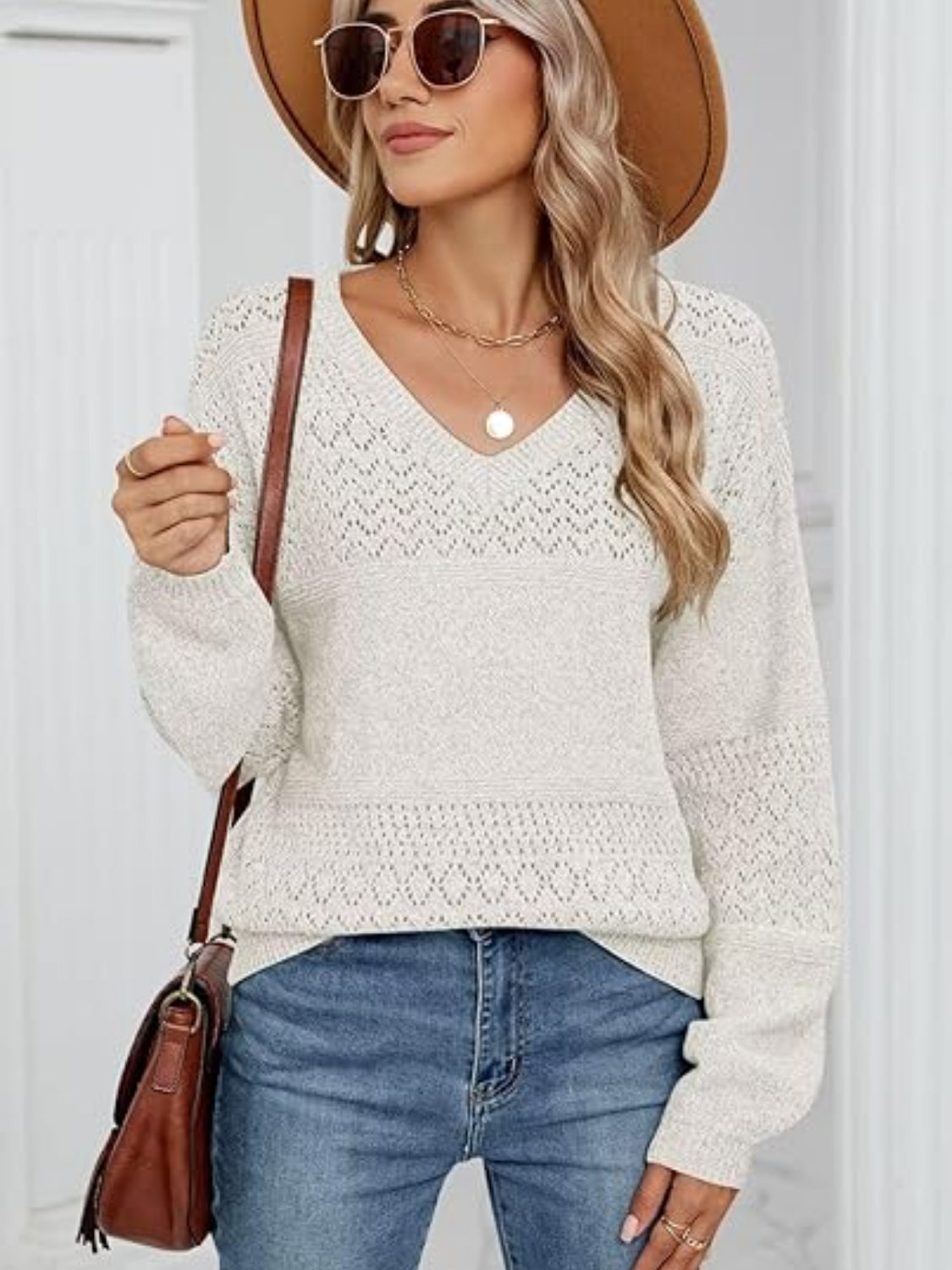 White eyelet stitch V-neck pullover sweater with long sleeves and a relaxed fit.