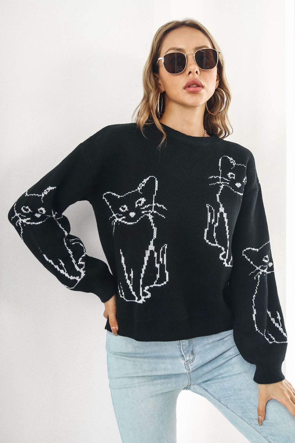 Black acrylic sweater with white cat intarsia knit pattern, crew neck, and long sleeves.