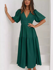 Green midi dress with V-neck, puff sleeves, elastic waist, and tiered skirt.