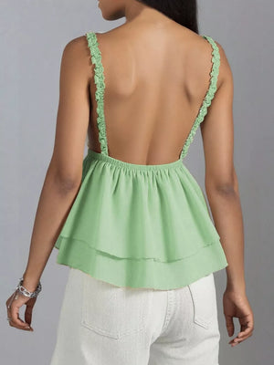 Green layered camisole with lace trim straps and a ruffled hem.