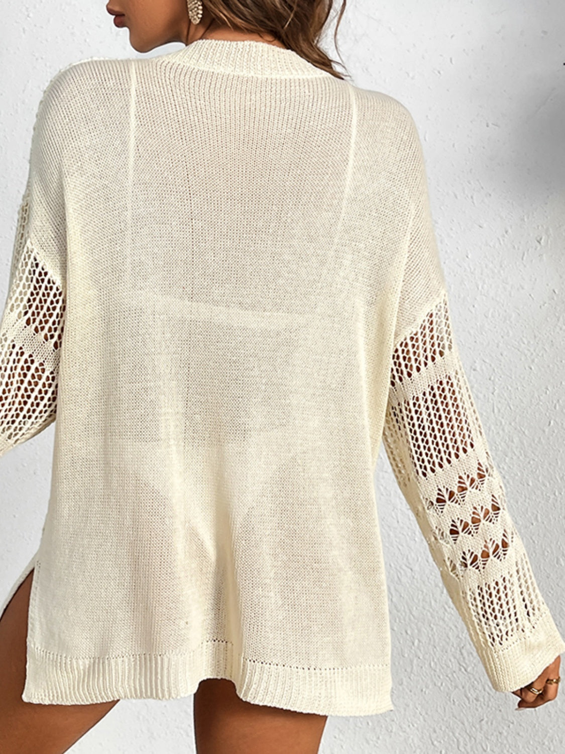 Open-knit tan cover-up with slouchy fit and cutout sleeves.