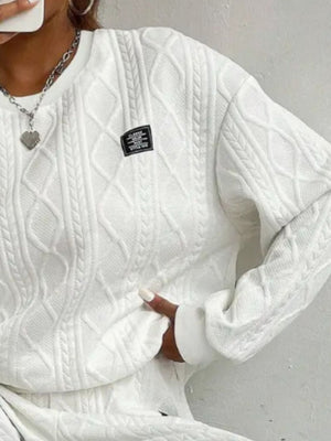 White cable knit loungewear set with textured diamond pattern and crew neck.
