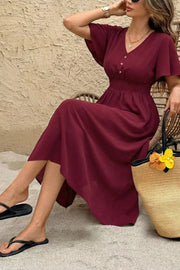 Burgundy V-neck flutter sleeve midi dress with smocked waist and button detail