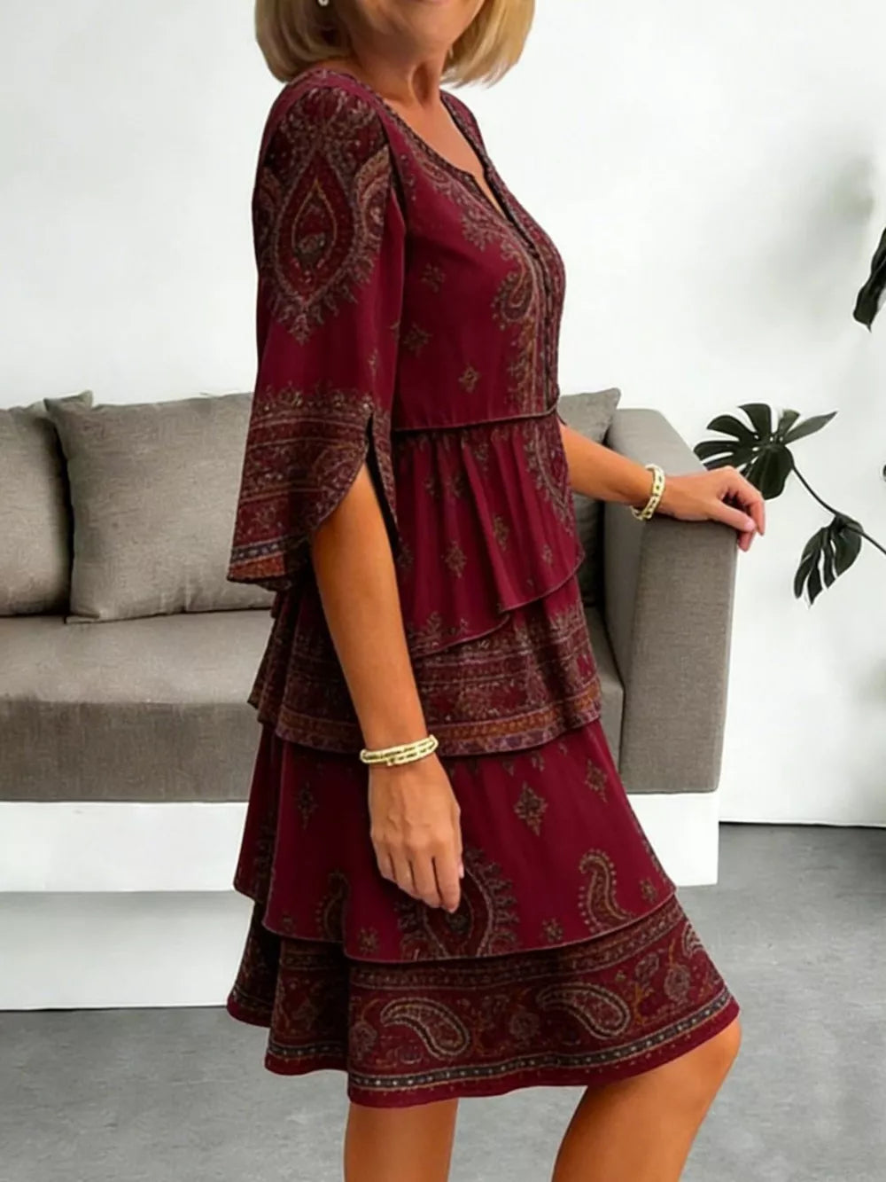 Burgundy paisley print mini dress with tiered ruffles and split sleeves.