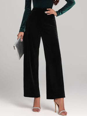 Black velvet palazzo trousers with a wide leg and high waist.