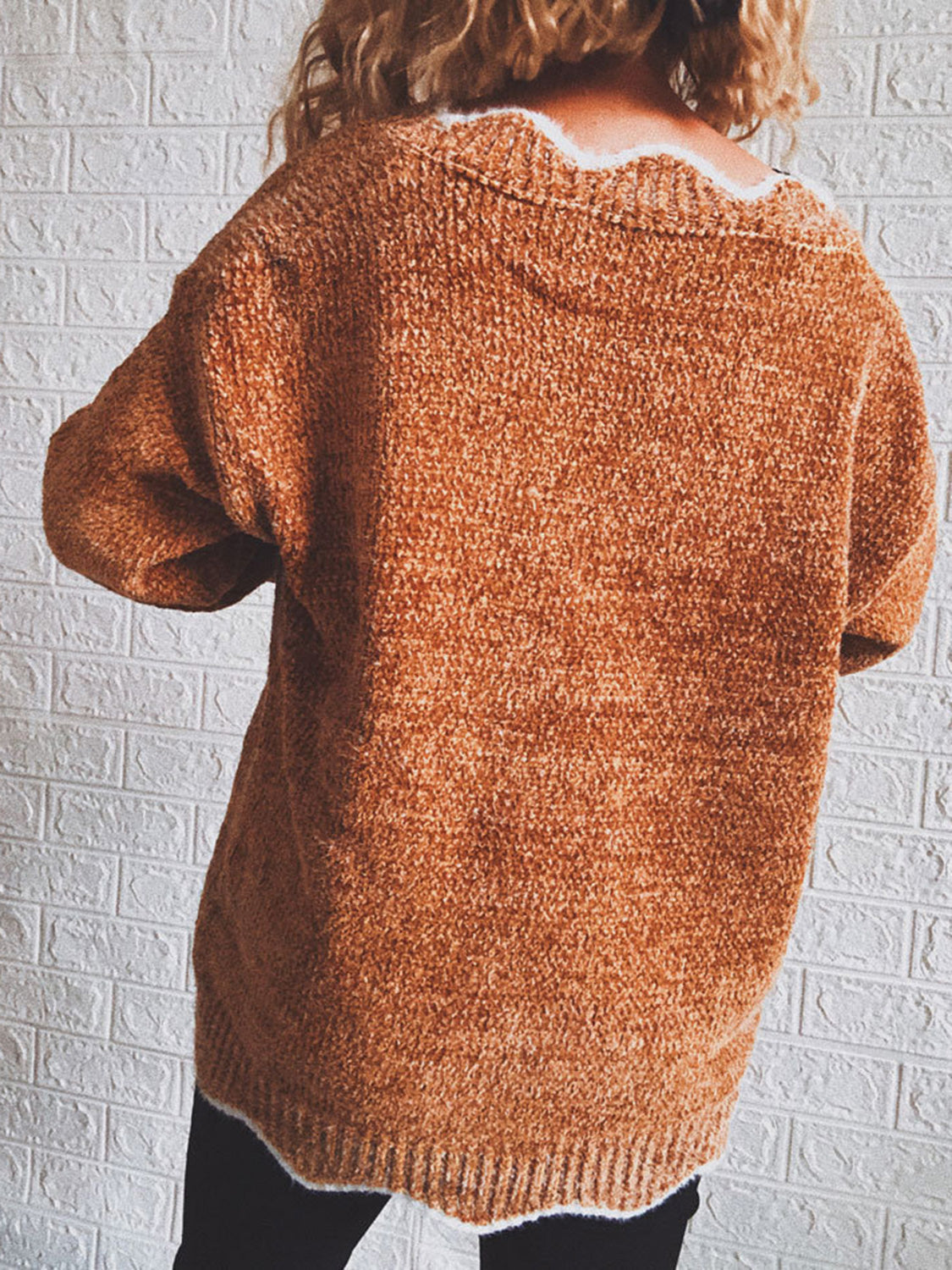 Acrylic v-neck sweater in Red Orange with scalloped trim detail and textured knit.