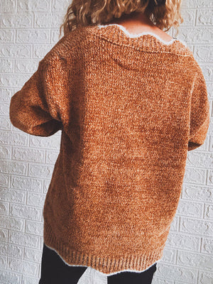 Acrylic v-neck sweater in Red Orange with scalloped trim detail and textured knit.