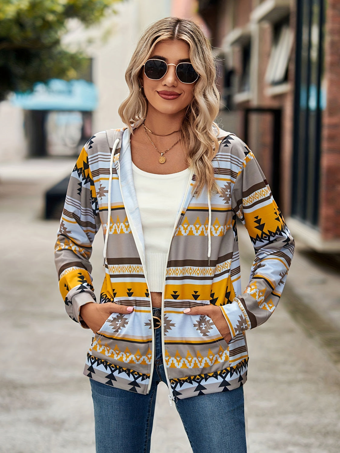 Aztec print zip-up hooded jacket with pockets in gray, yellow, and blue.