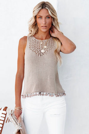 Tan openwork knit tank top with crochet neckline and tassel trim.