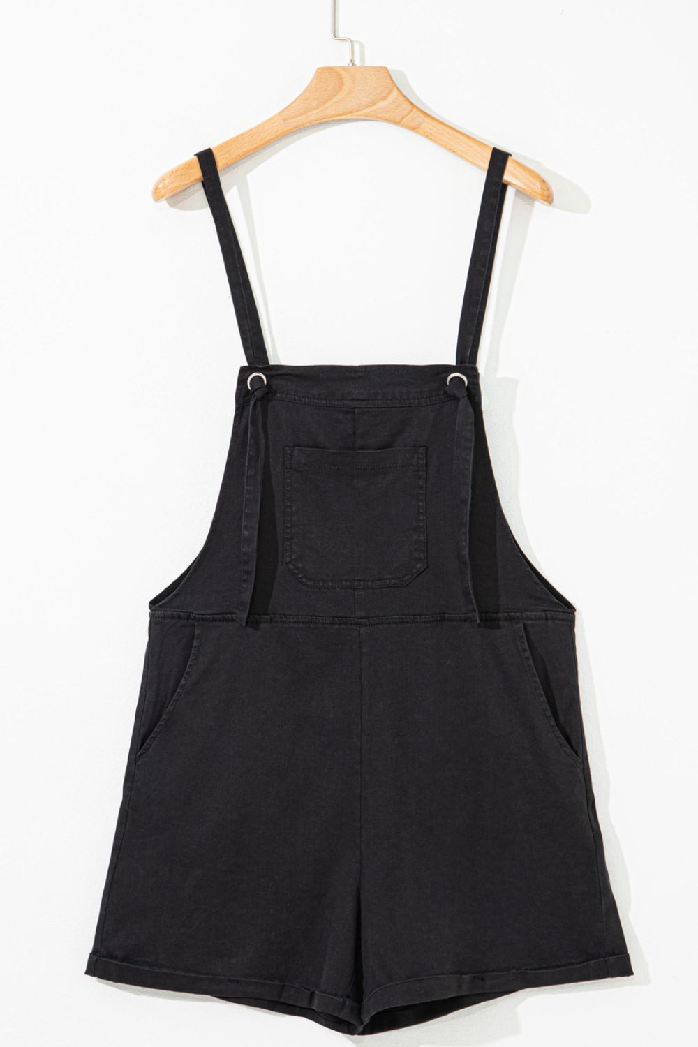 Black denim romper with adjustable straps and chest pocket