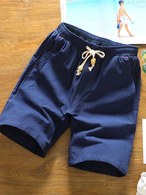 Navy relaxed fit drawstring chino shorts with wooden bead details and red stitching accents.
