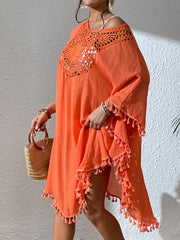 Orange crochet yoke tassel kaftan dress with wide sleeves and a flowy hem.