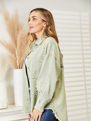 Light green distressed denim overshirt with raw hem and buttoned front.