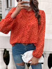 Orange-red eyelet embroidered blouse with ruffle collar and button front.