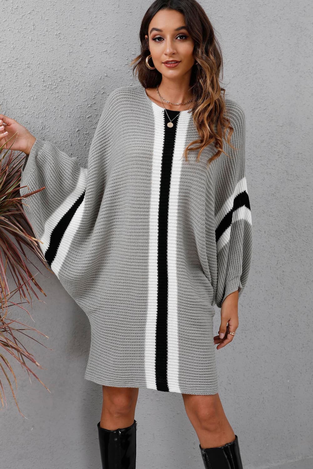 Light gray oversized knit cocoon dress with black and white vertical stripes and sleeve stripes.