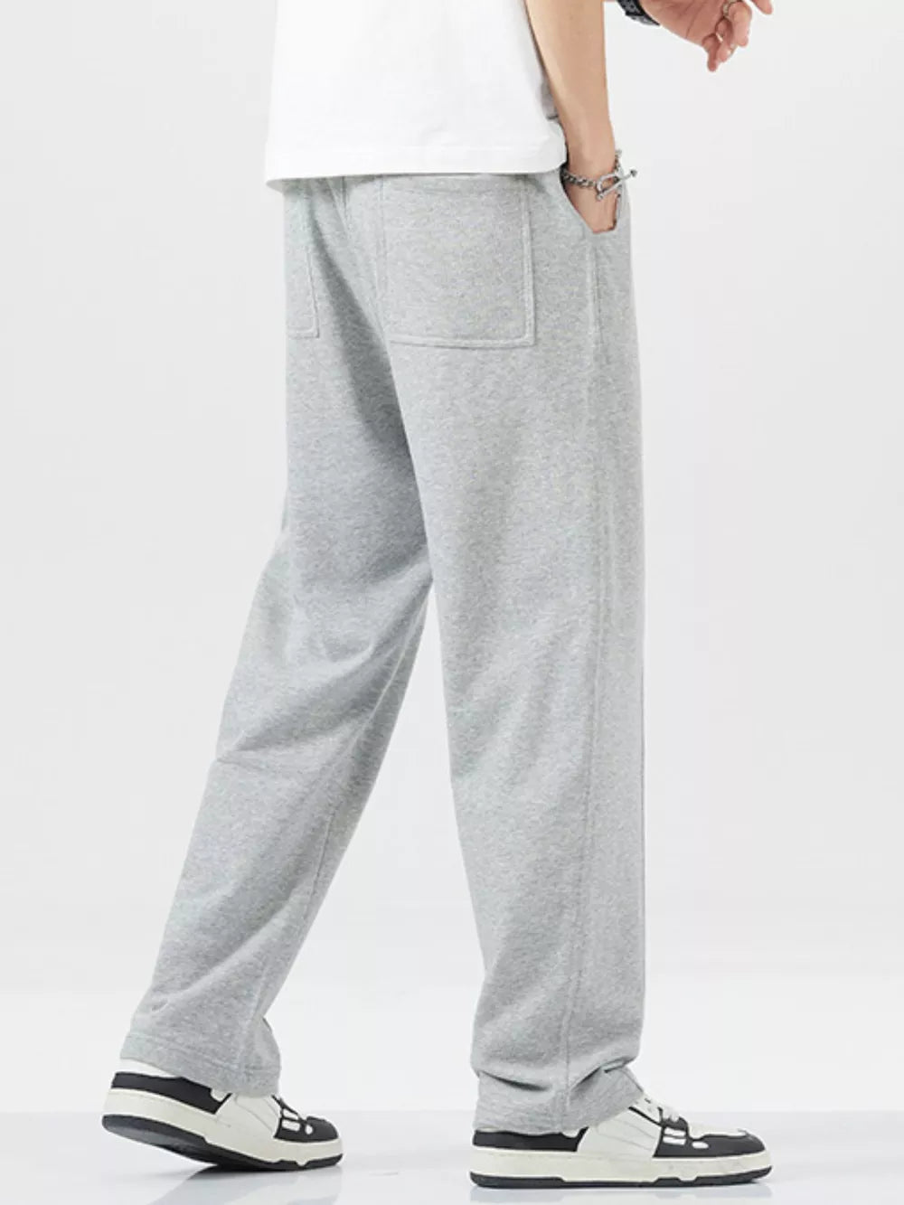 Men's grey sweatpants with drawstring and back pockets, relaxed fit.