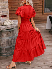 Deep red tiered maxi dress with puff sleeves and ruffled neckline.
