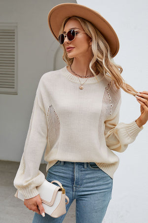 Cream knit sweater with slit detail, crewneck, and balloon sleeves.