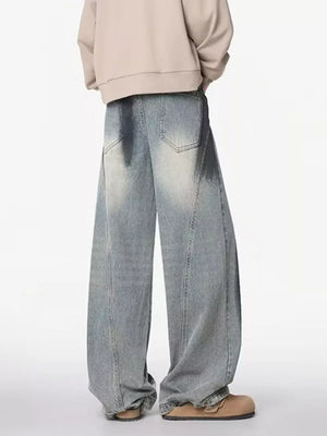 Distressed wide-leg jeans with a belted detail in light wash denim.